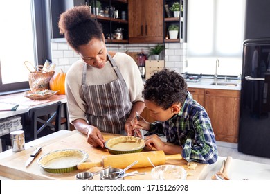 Woman prepare pie in the kitchen and learn his son cooking