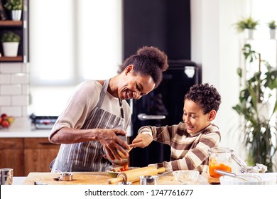 Woman prepare pie in the kitchen and learn his son cooking