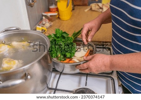 woman prepares broth in the kitchen at home. Homemade food
