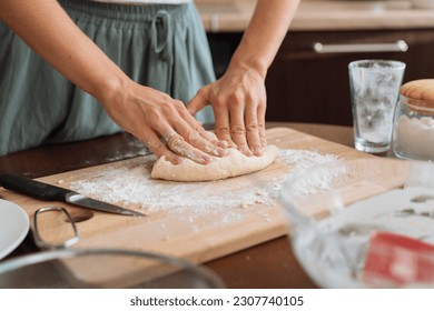 Woman preparing bread dough on wooden table at home close up - Powered by Shutterstock