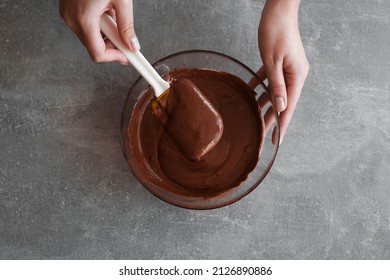 woman preparing chocolate mousse close-up top view