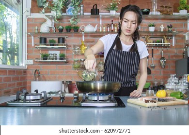 Woman Preparing Cooking Salmon Fish In Luxury Kitchen 