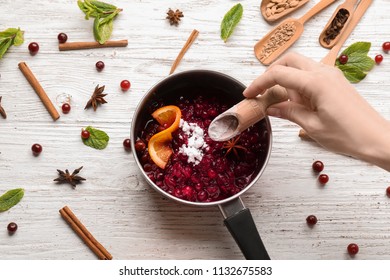 Woman Preparing Delicious Cranberry Sauce At Table, Top View