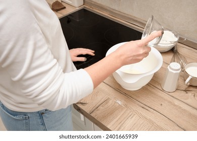 Woman preparing dough in the kitchen, close-up of hands. - Powered by Shutterstock