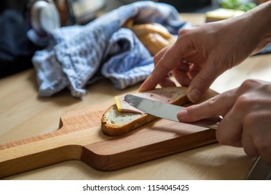 Woman Preparing And Eating Gourmet Belgian Duck Liver Pate Bread In Domestic Kitchen