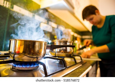 Woman preparing food in kitchen - Shutterstock ID 518576872
