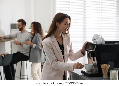 Woman preparing fresh aromatic coffee with modern machine in office - Shutterstock ID 2092352326