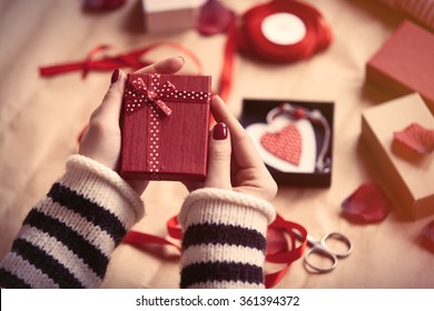 Woman preparing gift for wrapping for Valentine's Day - Shutterstock ID 361394372