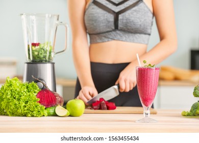 Woman Preparing Healthy Smoothie In Kitchen