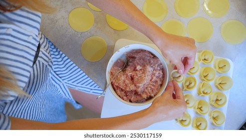 Woman Preparing Homemade Ravioli in a Modern Kitchen. High quality photo - Powered by Shutterstock