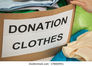 Woman Preparing The Old Clothes She Wants To Donate For Charity.