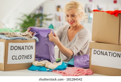 Woman Preparing The Old Clothes She Wants To Donate For Charity.