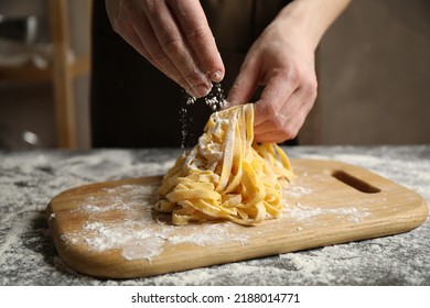 Woman preparing pasta at table, closeup view - Powered by Shutterstock