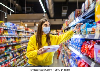 Woman Preparing For Pathogen Virus Pandemic Spread Quarantine.Choosing Nonperishable Food Essentials.Budget Buying At A Supply Store.Pandemic Quarantine Preparation.Emergency To Buy List Stock Photo