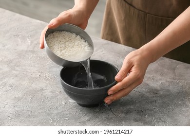 Woman Preparing Rice Water On Table