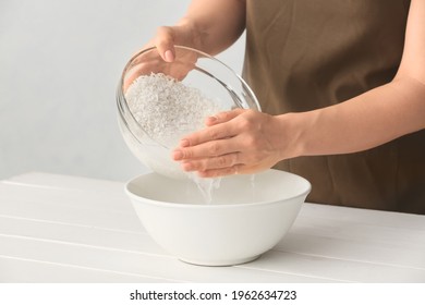 Woman Preparing Rice Water On Table