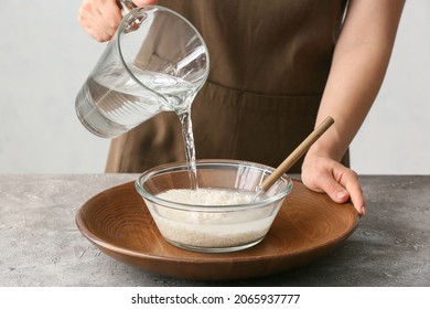 Woman Preparing Rice Water On Table