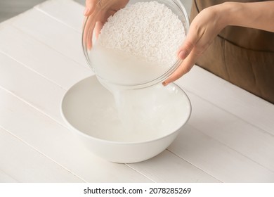 Woman Preparing Rice Water On Table