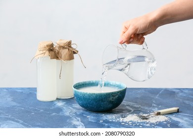 Woman Preparing Rice Water On Table