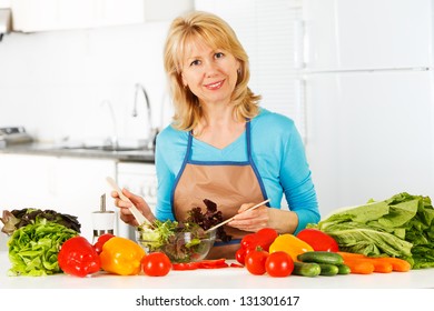 Woman preparing salad in the kitchen. Healthy Eating. - Powered by Shutterstock