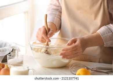 Woman Preparing Tasty Basque Burnt Cheesecake In Kitchen