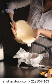 Woman Preparing Tasty Basque Burnt Cheesecake In Kitchen