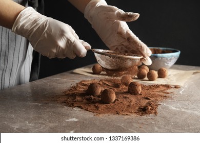 Woman Preparing Tasty Chocolate Truffles At Table, Closeup