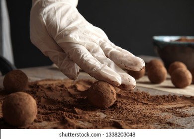 Woman Preparing Tasty Chocolate Truffles At Table, Closeup