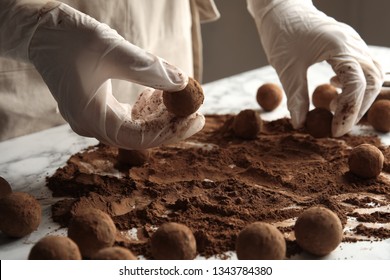 Woman Preparing Tasty Chocolate Truffles At Table, Closeup