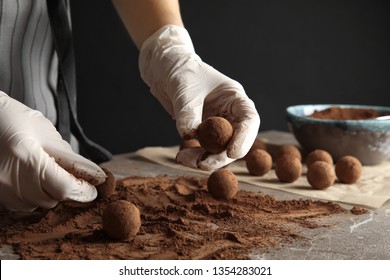 Woman Preparing Tasty Chocolate Truffles At Table, Closeup