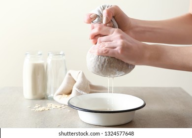 Woman Preparing Tasty Oat Milk On Table