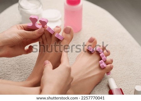 Woman preparing toenails for pedicure at home, closeup