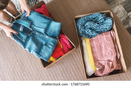 Woman preparing used clothes for clothing swap. Concept of waste problem in fashion industry.