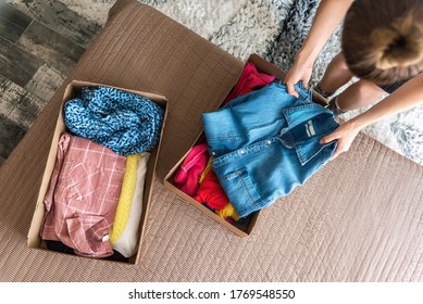Woman preparing used clothes for clothing swap. Concept of waste problem in fashion industry. - Shutterstock ID 1769548550