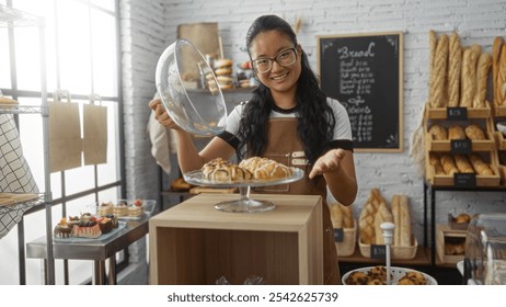 Woman presenting baked goods in a bakery with shelves of bread and pastries, showcasing an inviting interior. - Powered by Shutterstock