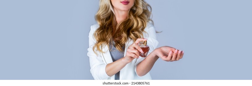 Woman presents perfumes fragrance. Perfume bottle woman spray aroma. Woman holding a perfumes bottle. Womans with perfum bottle. Beautiful girl using perfume. Woman with bottle of perfume.