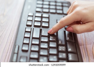 Woman presses the Enter key on the keyboard. - Shutterstock ID 1292059099
