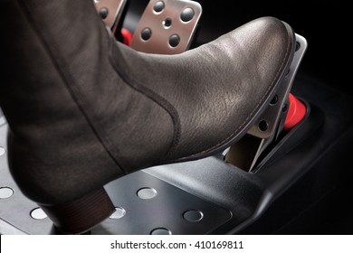 Woman Pressing The Gas Pedal With Her Foot. Close Up.