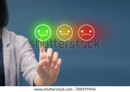 Woman pressing happy smiley face emoticon on virtual touch screen. Customer service evaluation and rating concept.