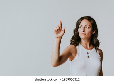 Woman pressing her finger to a screen - Powered by Shutterstock