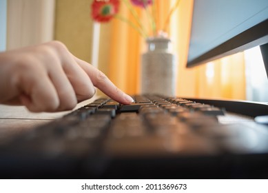 Woman Is Pressing A Key On The Computer Keyboard By Her Index Finger Close Up.