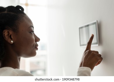 Woman Pressing On Smart Home Automation Panel Monitor