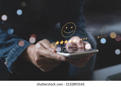 Woman Pressing Smiley Face Emoticon On Virtual Touch Screen On Mobile Smart Phone. Customer Review, Service Evaluation Concept.