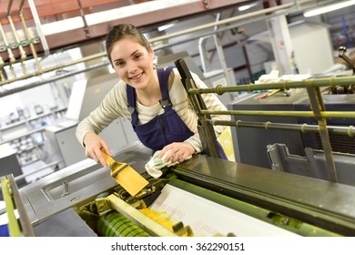 Woman In Printshop Preparing Machine