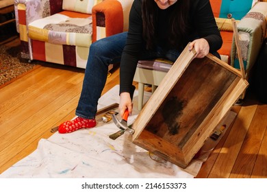 Woman In Process Of Fixing Old Box Made Of Wood With Hammer In Workshop For Renovation. Giving Old Things New Life. Reuse Of Aged. Sustainable Actions For Helping Planet.