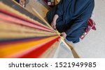 A woman produces traditional Sadu fabric in the Souq Okaz Festival in Taif, Saudi Arabia.