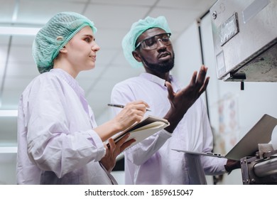 Woman Production Supervisor Working With African Worker In Food Factory To Checking And Report Machine Problem To Engineer In Production Line.