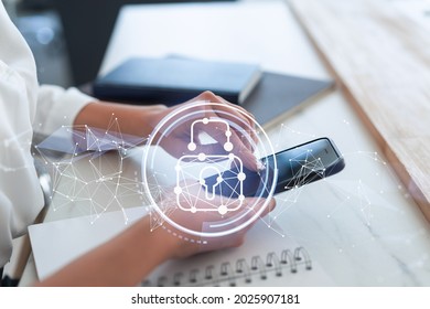 A woman programmer is browsing the Internet in smart phone to protect a cyber security from hacker attacks and save clients confidential data. Padlock Hologram icons over the typing hands. Formal wear