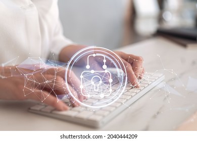 A woman programmer is typing a code on computer to protect a cyber security from hacker attacks and save clients confidential data. Padlock Hologram icons over the typing hands. Formal wear.