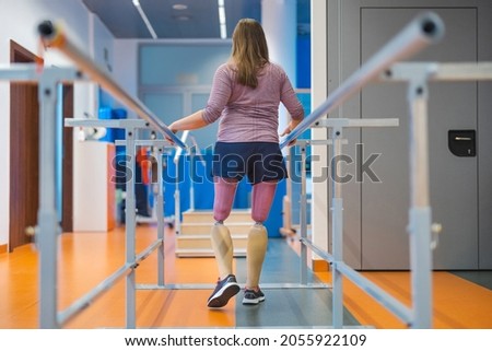 Woman with prosthetic legs using parallel bars
 商業照片 © 